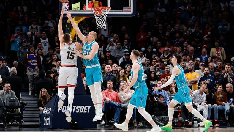 Dec 18, 2022; Denver, Colorado, USA; Denver Nuggets center Nikola Jokic (15) drives to the net against Charlotte Hornets center Mason Plumlee (24) as forward Gordon Hayward (20) and guard LaMelo Ball (1) defend in the first quarter at Ball Arena. Mandatory Credit: Isaiah J. Downing-USA TODAY Sports