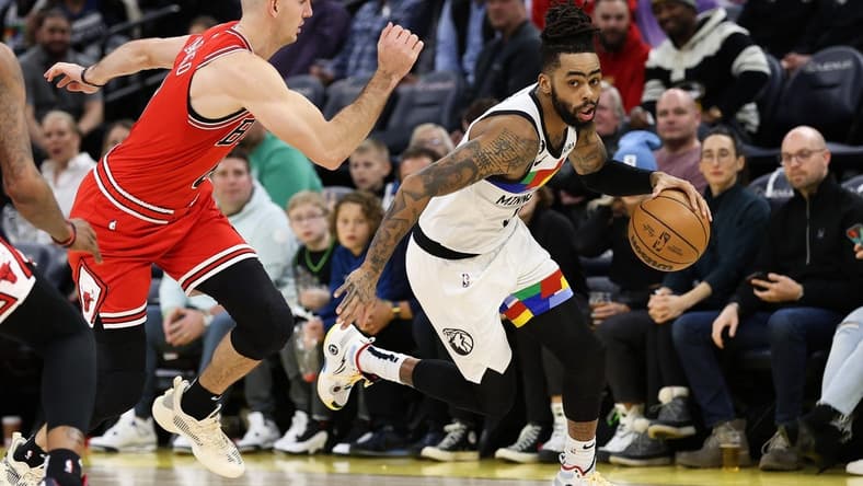 Dec 18, 2022; Minneapolis, Minnesota, USA; Minnesota Timberwolves guard D'Angelo Russell (0) dribbles while Chicago Bulls guard Alex Caruso (6) defends during the second quarter at Target Center. Mandatory Credit: Matt Krohn-USA TODAY Sports