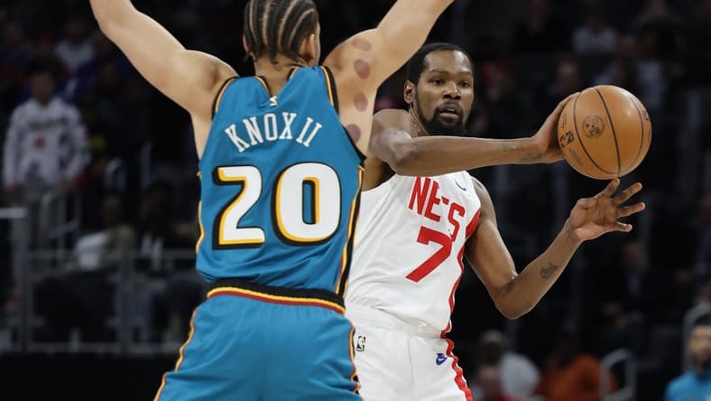 Dec 18, 2022; Detroit, Michigan, USA; Brooklyn Nets forward Kevin Durant (7) passes defended by Detroit Pistons forward Kevin Knox II (20) in the first half at Little Caesars Arena. Mandatory Credit: Rick Osentoski-USA TODAY Sports