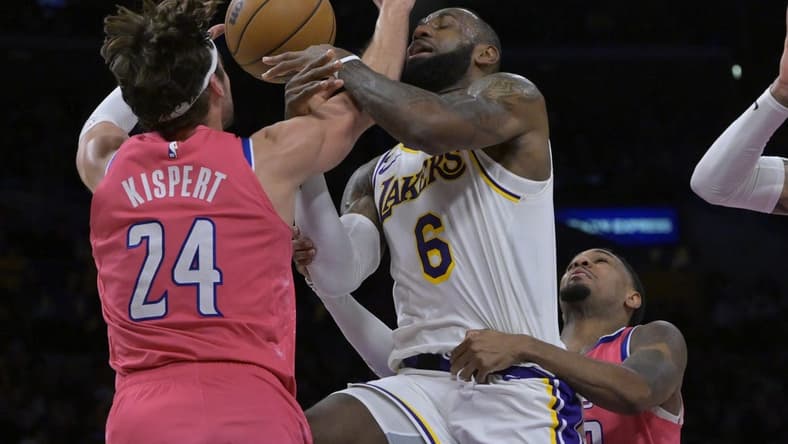 Dec 18, 2022; Los Angeles, California, USA; Washington Wizards forward Corey Kispert (24) fouls Los Angeles Lakers forward LeBron James (6) in the first half at Crypto.com Arena. Mandatory Credit: Jayne Kamin-Oncea-USA TODAY Sports