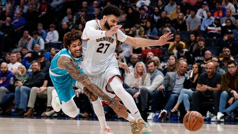 Dec 18, 2022; Denver, Colorado, USA; Charlotte Hornets guard Kelly Oubre Jr. (12) knocks the ball away from Denver Nuggets guard Jamal Murray (27) in the fourth quarter at Ball Arena. Mandatory Credit: Isaiah J. Downing-USA TODAY Sports
