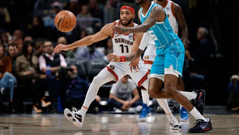 Dec 18, 2022; Denver, Colorado, USA; Charlotte Hornets forward Jalen McDaniels (6) passes the ball as Denver Nuggets forward Bruce Brown (11) guards in the fourth quarter at Ball Arena. Mandatory Credit: Isaiah J. Downing-USA TODAY Sports