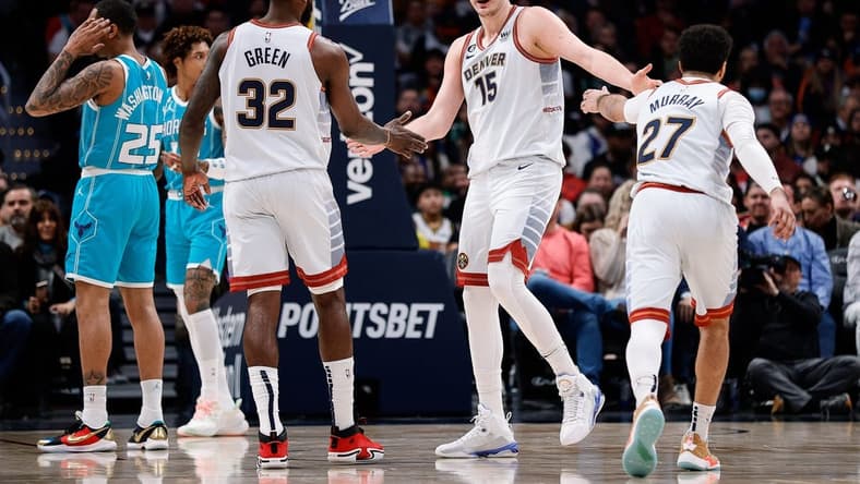 Dec 18, 2022; Denver, Colorado, USA; Denver Nuggets center Nikola Jokic (15) reacts with forward Jeff Green (32) and guard Jamal Murray (27) in the second quarter against the Charlotte Hornets at Ball Arena. Mandatory Credit: Isaiah J. Downing-USA TODAY Sports