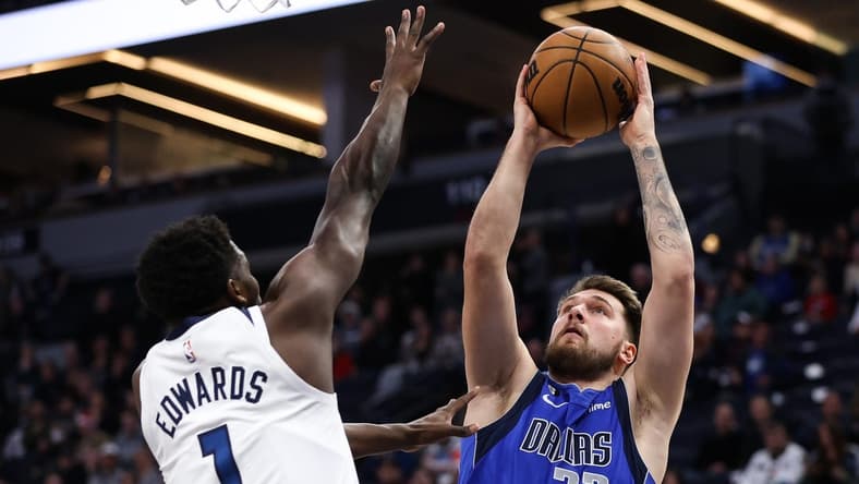 Dec 19, 2022; Minneapolis, Minnesota, USA; Dallas Mavericks guard Luka Doncic (77) shoots while Minnesota Timberwolves guard Anthony Edwards (1) defends during the first quarter at Target Center. Mandatory Credit: Matt Krohn-USA TODAY Sports