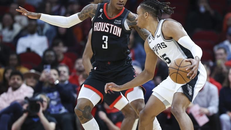 Dec 19, 2022; Houston, Texas, USA; San Antonio Spurs guard Romeo Langford (35) controls the ball as Houston Rockets guard Kevin Porter Jr. (3) defends during the first quarter at Toyota Center. Mandatory Credit: Troy Taormina-USA TODAY Sports