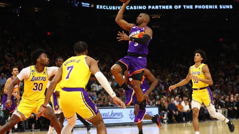 Dec 19, 2022; Phoenix, Arizona, USA; Phoenix Suns guard Chris Paul (3) drives to the hoop against the Los Angeles Lakers in the second half at Footprint Center. Mandatory Credit: Mark J. Rebilas-USA TODAY Sports