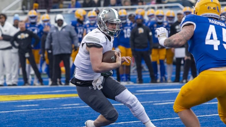 Dec 20, 2022; Boise, Idaho, USA; Eastern Michigan Eagles quarterback Taylor Powell (7) runs for a first down during the first half of action of the Famous Idaho Potato Bowl against the San Jose State Spartans at Albertsons Stadium. Mandatory Credit: Brian Losness-USA TODAY Sports