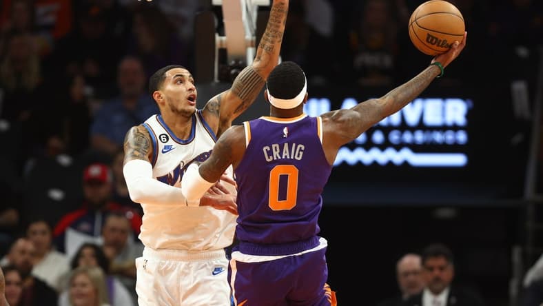 Dec 20, 2022; Phoenix, Arizona, USA; Washington Wizards forward Kyle Kuzma (left) defends against Phoenix Suns forward Torrey Craig in the first half at Footprint Center. Mandatory Credit: Mark J. Rebilas-USA TODAY Sports