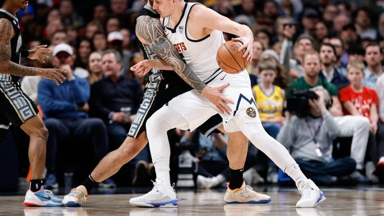 Dec 20, 2022; Denver, Colorado, USA; Denver Nuggets center Nikola Jokic (15) controls the ball as Memphis Grizzlies center Steven Adams (4) guards in the first quarter at Ball Arena. Mandatory Credit: Isaiah J. Downing-USA TODAY Sports