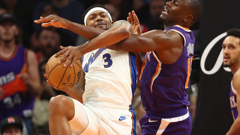 Dec 20, 2022; Phoenix, Arizona, USA; Washington Wizards guard Bradley Beal (3) is fouled by Phoenix Suns center Bismack Biyombo in the second half at Footprint Center. Mandatory Credit: Mark J. Rebilas-USA TODAY Sports