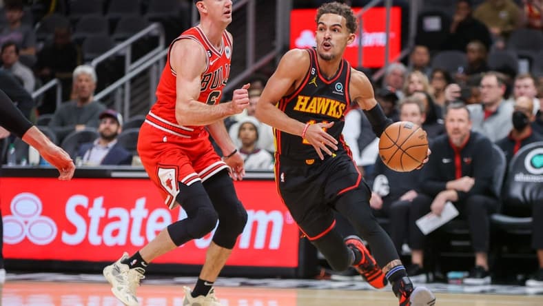 Dec 21, 2022; Atlanta, Georgia, USA; Atlanta Hawks guard Trae Young (11) drives on Chicago Bulls guard Alex Caruso (6) in the first quarter at State Farm Arena. Mandatory Credit: Brett Davis-USA TODAY Sports