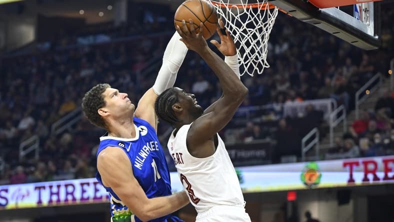 Dec 21, 2022; Cleveland, Ohio, USA; Milwaukee Bucks center Brook Lopez (11) defends a shot by Cleveland Cavaliers guard Caris LeVert (3) in the second quarter at Rocket Mortgage FieldHouse. Mandatory Credit: David Richard-USA TODAY Sports
