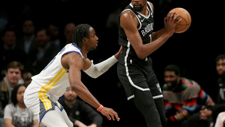 Dec 21, 2022; Brooklyn, New York, USA; Brooklyn Nets forward Kevin Durant (7) controls the ball against Golden State Warriors forward Jonathan Kuminga (00) during the first quarter at Barclays Center. Mandatory Credit: Brad Penner-USA TODAY Sports