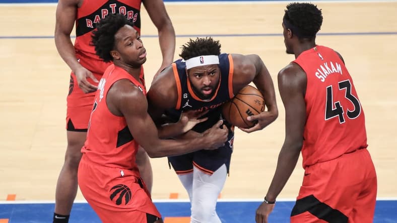 Dec 21, 2022; New York, New York, USA; New York Knicks center Mitchell Robinson (23) and Toronto Raptors forward O.G. Anunoby (3) play for the ball in the second quarter at Madison Square Garden. Mandatory Credit: Wendell Cruz-USA TODAY Sports