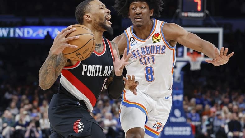 Dec 21, 2022; Oklahoma City, Oklahoma, USA; Portland Trail Blazers guard Damian Lillard (0) is defended by Oklahoma City Thunder forward Jalen Williams (8) on a drive during the second quarter at Paycom Center. Mandatory Credit: Alonzo Adams-USA TODAY Sports