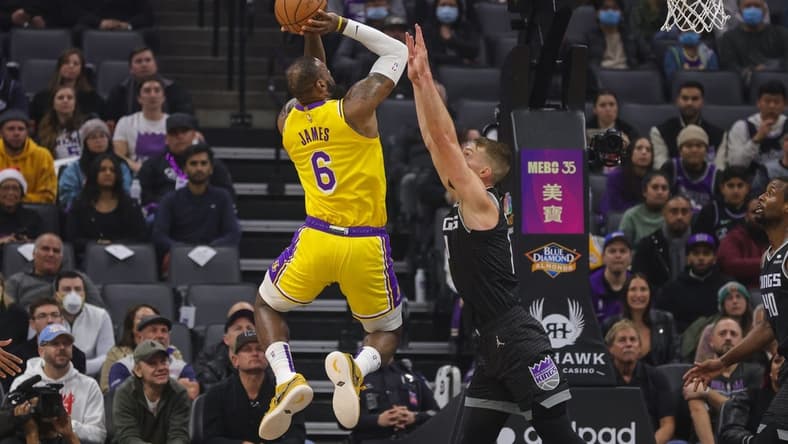 Dec 21, 2022; Sacramento, California, USA; Los Angeles Lakers forward LeBron James (6) shoots the ball over Sacramento Kings forward Domantas Sabonis (10) during the first quarter at Golden 1 Center. Mandatory Credit: Sergio Estrada-USA TODAY Sports