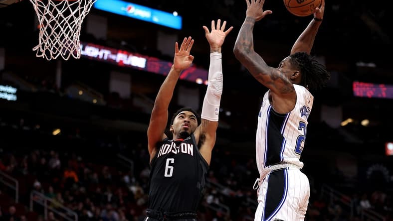 Dec 21, 2022; Houston, Texas, USA; Orlando Magic forward Admiral Schofield (25) attempts a slam dunk while Houston Rockets forward KJ Martin (6) defends during the fourth quarter at Toyota Center. Mandatory Credit: Erik Williams-USA TODAY Sports