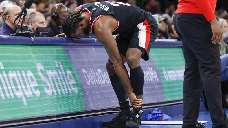 Dec 21, 2022; Oklahoma City, Oklahoma, USA; Portland Trail Blazers forward Justise Winslow (26) grabs his left ankle after a play against the Oklahoma City Thunder during the second half at Paycom Center. Oklahoma City won 101-98. Mandatory Credit: Alonzo Adams-USA TODAY Sports