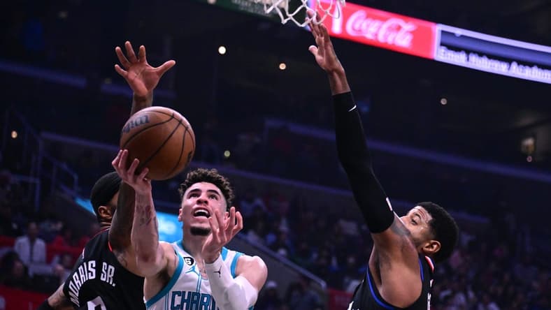 Dec 21, 2022; Los Angeles, California, USA; Charlotte Hornets guard LaMelo Ball (1) goes to the basket past Los Angeles Clippers forward Marcus Morris (8) during the second quarter at Crypto.com Arena. Mandatory Credit: Richard Mackson-USA TODAY Sports