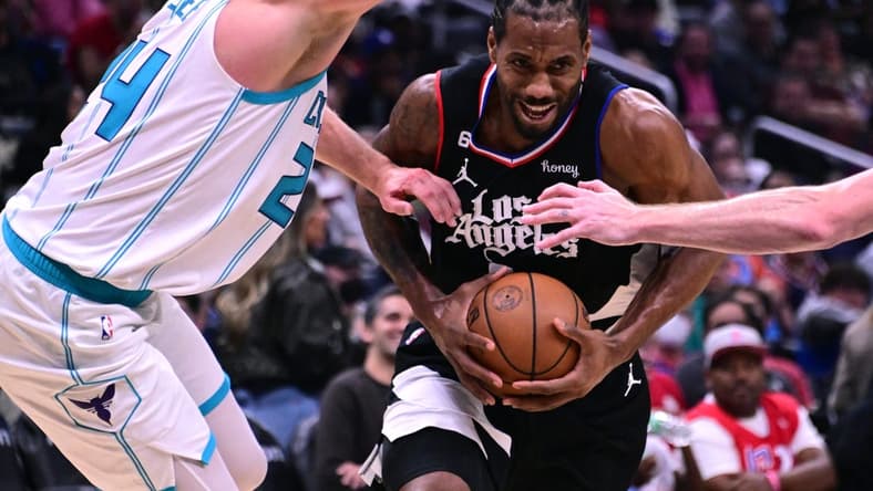 Dec 21, 2022; Los Angeles, California, USA; Los Angeles Clippers forward Kawhi Leonard (2) goes to the basket while defended by Charlotte Hornets center Mason Plumlee (24) during the third quarter at Crypto.com Arena. Mandatory Credit: Richard Mackson-USA TODAY Sports