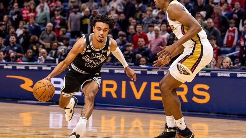 Dec 22, 2022; New Orleans, Louisiana, USA; San Antonio Spurs guard Tre Jones (33) drives to the basket against New Orleans Pelicans forward Herbert Jones (5) during the first half at Smoothie King Center. Mandatory Credit: Stephen Lew-USA TODAY Sports