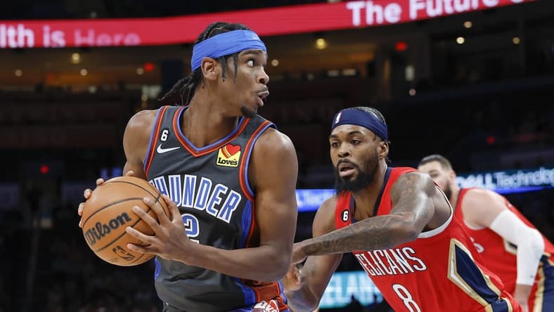 Dec 23, 2022; Oklahoma City, Oklahoma, USA; Oklahoma City Thunder guard Shai Gilgeous-Alexander (2) is defended by New Orleans Pelicans forward Naji Marshall (8) during the first quarter at Paycom Center. Mandatory Credit: Alonzo Adams-USA TODAY Sports