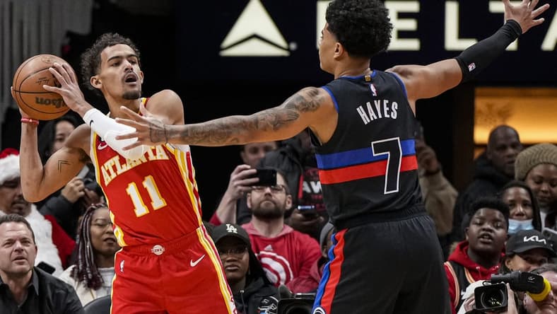 Dec 23, 2022; Atlanta, Georgia, USA; Atlanta Hawks guard Trae Young (11) looks for room to pass against Detroit Pistons guard Killian Hayes (7) during the first half at State Farm Arena. Mandatory Credit: Dale Zanine-USA TODAY Sports