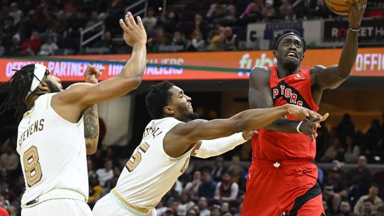 Dec 23, 2022; Cleveland, Ohio, USA; Toronto Raptors forward Pascal Siakam (43) drives to the basket beside Cleveland Cavaliers guard Donovan Mitchell (45) and forward Lamar Stevens (8) in the second quarter at Rocket Mortgage FieldHouse. Mandatory Credit: David Richard-USA TODAY Sports
