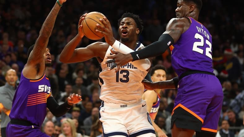 Dec 23, 2022; Phoenix, Arizona, USA; Memphis Grizzlies forward Jaren Jackson Jr. (13) drives to the basket against Phoenix Suns center Deandre Ayton (22) in the first half at Footprint Center. Mandatory Credit: Mark J. Rebilas-USA TODAY Sports
