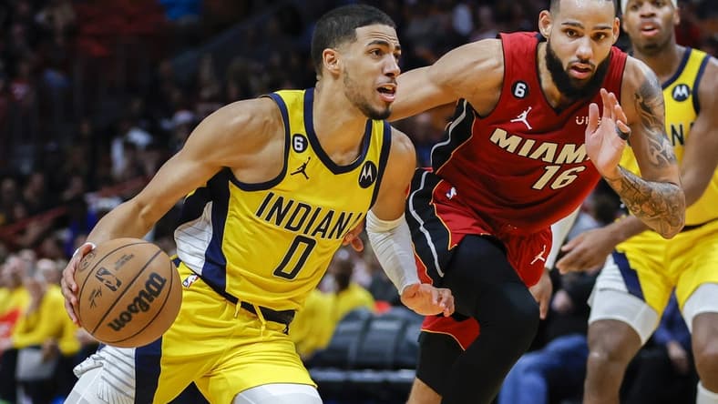 Dec 23, 2022; Miami, Florida, USA; Indiana Pacers guard Tyrese Haliburton (0) drives to the basket ahead of Miami Heat forward Caleb Martin (16) during the third quarter at FTX Arena. Mandatory Credit: Sam Navarro-USA TODAY Sports