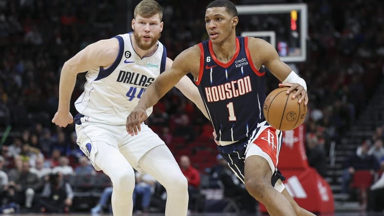 Dec 23, 2022; Houston, Texas, USA; Houston Rockets forward Jabari Smith Jr. (1) dribbles the ball as Dallas Mavericks forward Davis Bertans (44) defends during the first half at Toyota Center. Mandatory Credit: Troy Taormina-USA TODAY Sports