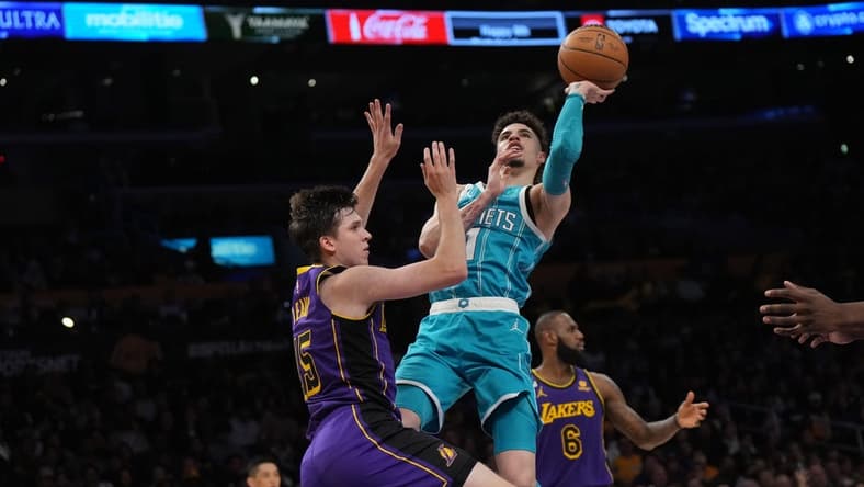 Dec 23, 2022; Los Angeles, California, USA; Charlotte Hornets guard LaMelo Ball (1) shoots the ball against Los Angeles Lakers guard Austin Reaves (15) in the first half at Crypto.com Arena. Mandatory Credit: Kirby Lee-USA TODAY Sports