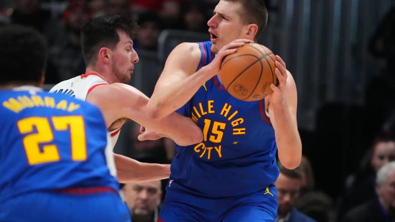 Dec 23, 2022; Denver, Colorado, USA; Portland Trail Blazers forward Drew Eubanks (24) elbows Denver Nuggets center Nikola Jokic (15) in the second half at Ball Arena. Mandatory Credit: Ron Chenoy-USA TODAY Sports