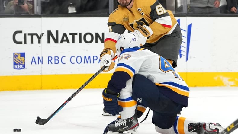 Dec 23, 2022; Las Vegas, Nevada, USA; Vegas Golden Knights right wing Mark Stone (61) sends a pass ahead of St. Louis Blues defenseman Torey Krug (47) during an overtime period at T-Mobile Arena. Mandatory Credit: Stephen R. Sylvanie-USA TODAY Sports