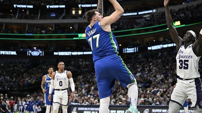 Dec 25, 2022; Dallas, Texas, USA; Dallas Mavericks guard Luka Doncic (77) shoots the ball over Los Angeles Lakers forward Wenyen Gabriel (35) during the second quarter at the American Airlines Center. Mandatory Credit: Jerome Miron-USA TODAY Sports