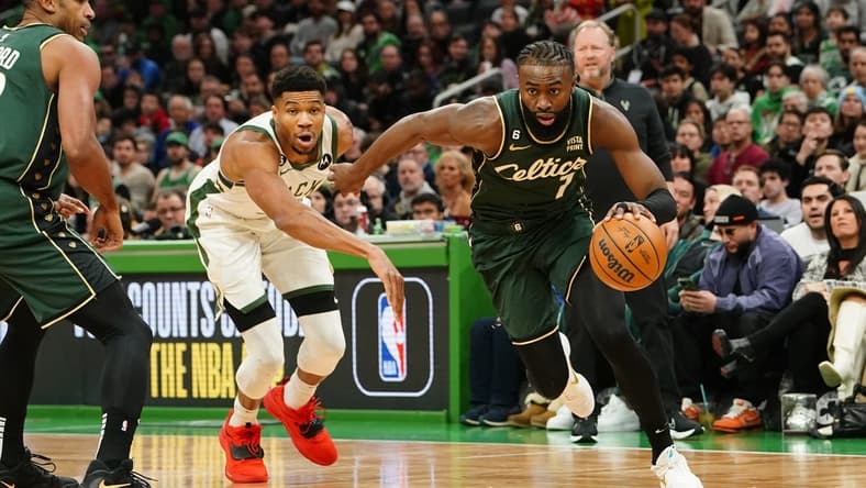Dec 25, 2022; Boston, Massachusetts, USA; Boston Celtics shooting guard Jaylen Brown (7) drives the ball against Milwaukee Bucks power forward Giannis Antetokounmpo (34) during the 1st quarter at TD Garden. Mandatory Credit: Gregory Fisher-USA TODAY Sports