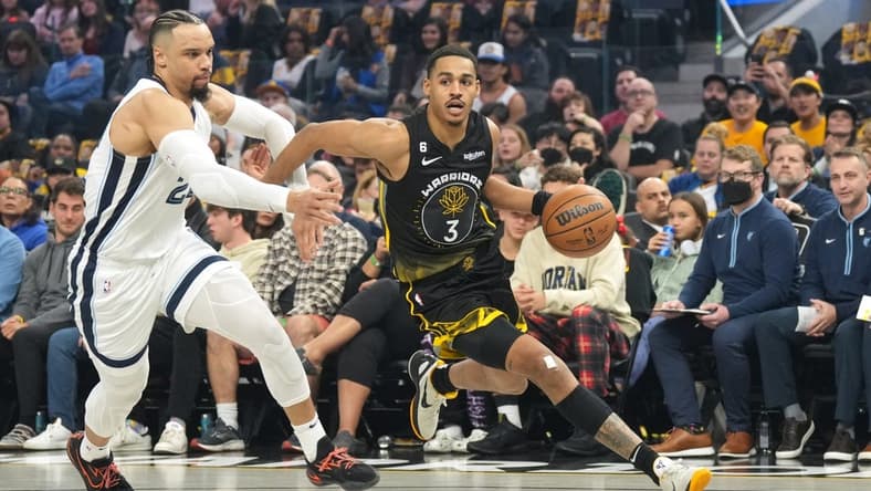 Dec 25, 2022; San Francisco, California, USA; Golden State Warriors guard Jordan Poole (3) dribbles against Memphis Grizzlies forward Dillon Brooks (24) during the first quarter at Chase Center. Mandatory Credit: Darren Yamashita-USA TODAY Sports