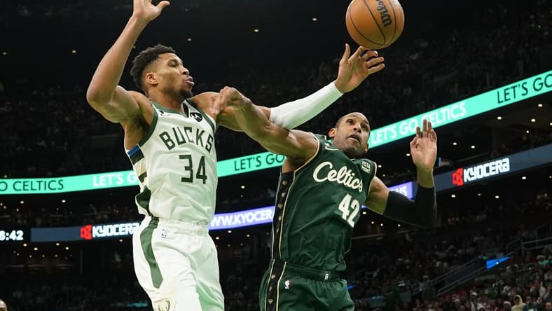 Dec 25, 2022; Boston, Massachusetts, USA; Boston Celtics center Al Horford (42) fouls Milwaukee Bucks power forward Giannis Antetokounmpo (34) attempting a shot during the second half at TD Garden. Mandatory Credit: Gregory Fisher-USA TODAY Sports
