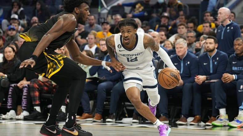 Dec 25, 2022; San Francisco, California, USA; Memphis Grizzlies guard Ja Morant (12) dribbles against Golden State Warriors center James Wiseman (33) during the third quarter at Chase Center. Mandatory Credit: Darren Yamashita-USA TODAY Sports