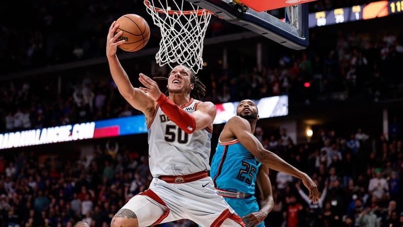 Dec 25, 2022; Denver, Colorado, USA; Denver Nuggets forward Aaron Gordon (50) drives to the net against Phoenix Suns forward Mikal Bridges (25) in overtime at Ball Arena. Mandatory Credit: Isaiah J. Downing-USA TODAY Sports