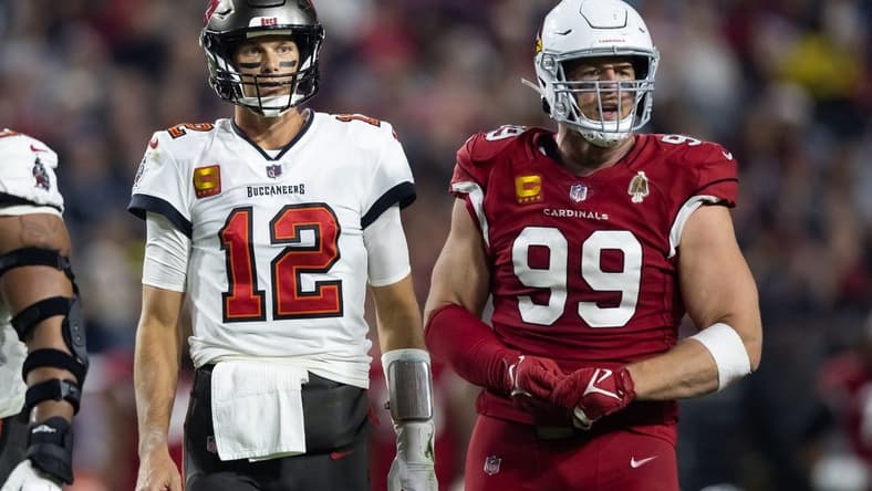 Dec 25, 2022; Glendale, Arizona, USA; Tampa Bay Buccaneers quarterback Tom Brady (12) alongside Arizona Cardinals defensive end J.J. Watt (99) at State Farm Stadium. Mandatory Credit: Mark J. Rebilas-USA TODAY Sports