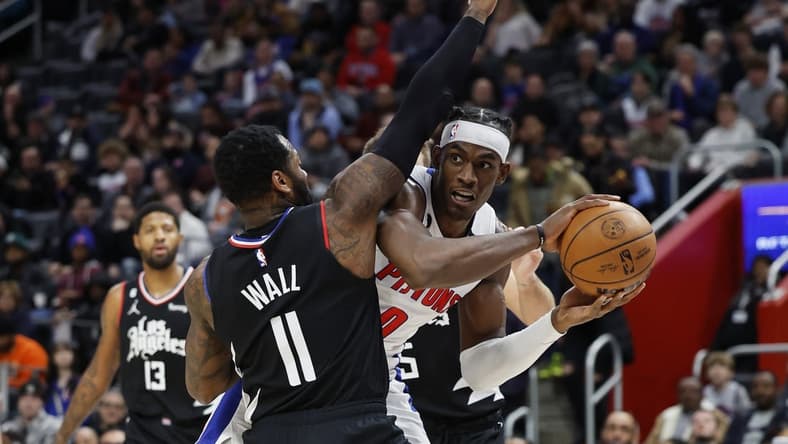 Dec 26, 2022; Detroit, Michigan, USA; Detroit Pistons center Jalen Duren (0) is defended by LA Clippers guard John Wall (11) in the first half at Little Caesars Arena. Mandatory Credit: Rick Osentoski-USA TODAY Sports