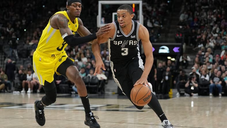 Dec 26, 2022; San Antonio, Texas, USA; San Antonio Spurs forward Keldon Johnson (3) dribbles past Utah Jazz forward Jarred Vanderbilt (8) in the first half at the AT&T Center. Mandatory Credit: Daniel Dunn-USA TODAY Sports