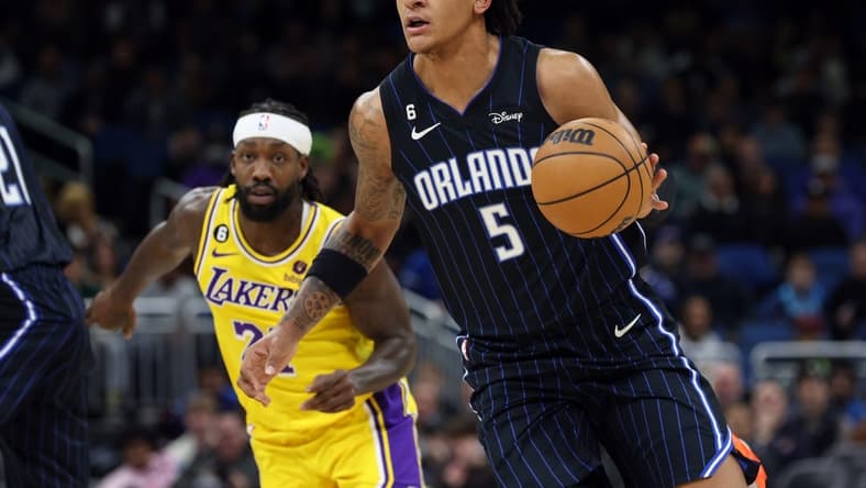 Dec 27, 2022; Orlando, Florida, USA; Orlando Magic forward Paolo Banchero (5) drives to the basket against the Los Angeles Lakers during the first quarter at Amway Center. Mandatory Credit: Kim Klement-USA TODAY Sports