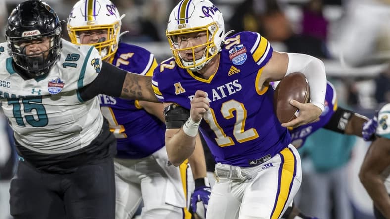 Dec 27, 2022; Birmingham, Alabama, USA; East Carolina Pirates quarterback Holton Ahlers (12) runs the ball against the Coastal Carolina Chanticleers in the 2022 Birmingham Bowl at Protective Stadium. Mandatory Credit: Vasha Hunt-USA TODAY Sports