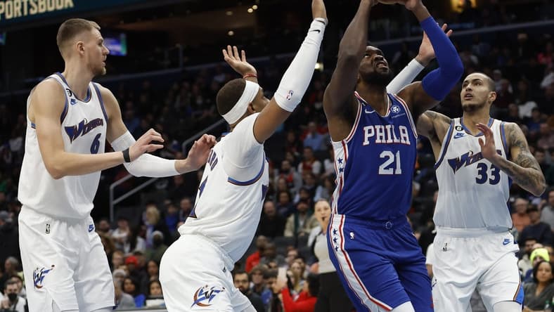 Dec 27, 2022; Washington, District of Columbia, USA;Philadelphia 76ers center Joel Embiid (21) shoots the ball as Washington Wizards center Daniel Gafford (21) and Wizards forward Kyle Kuzma (33) defend in the first quarter at Capital One Arena. Mandatory Credit: Geoff Burke-USA TODAY Sports