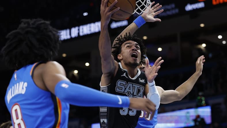 Dec 27, 2022; Oklahoma City, Oklahoma, USA; San Antonio Spurs guard Tre Jones (33) goes to the basket against the Oklahoma City Thunder during the first quarter at Paycom Center. Mandatory Credit: Alonzo Adams-USA TODAY Sports
