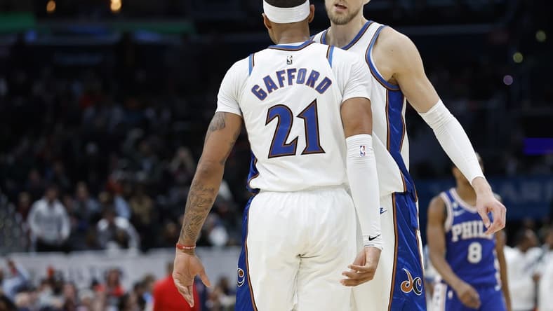 Dec 27, 2022; Washington, District of Columbia, USA; Washington Wizards center Kristaps Porzingis (6) celebrates with Wizards center Daniel Gafford (21) in the final seconds against the Philadelphia 76ers in the fourth quarter at Capital One Arena. Mandatory Credit: Geoff Burke-USA TODAY Sports