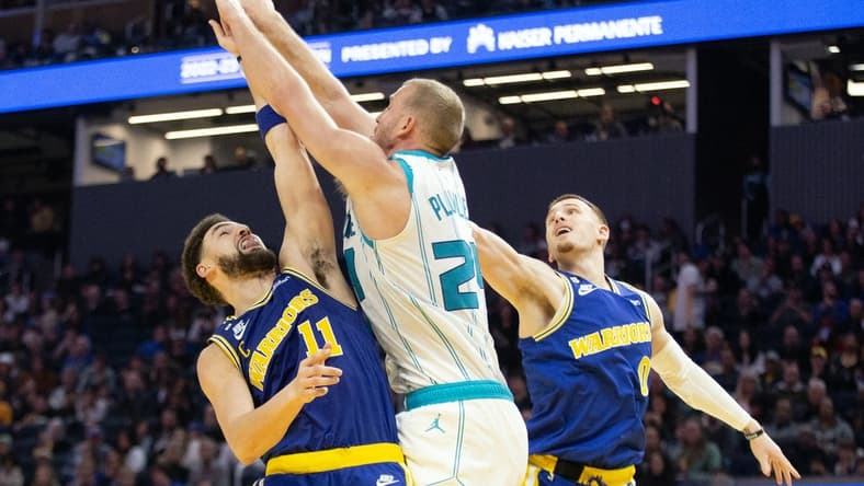 Dec 27, 2022; San Francisco, California, USA; Charlotte Hornets forward Mason Plumlee (24) knocks away a rebound between Golden State Warriors guards Klay Thompson (11) and Donte DiVincenzo (0) during the second quarter at Chase Center. Mandatory Credit: D. Ross Cameron-USA TODAY Sports