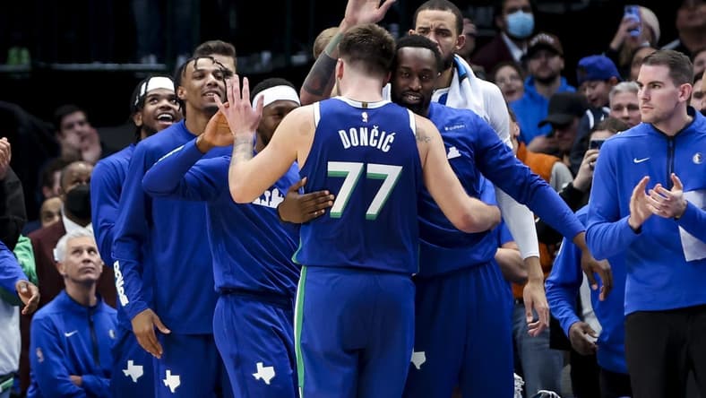 Dec 27, 2022; Dallas, Texas, USA; Dallas Mavericks guard Luka Doncic (77) celebrates with teammates after leaving the game in overtime against the New York Knicks at American Airlines Center. Mandatory Credit: Kevin Jairaj-USA TODAY Sports